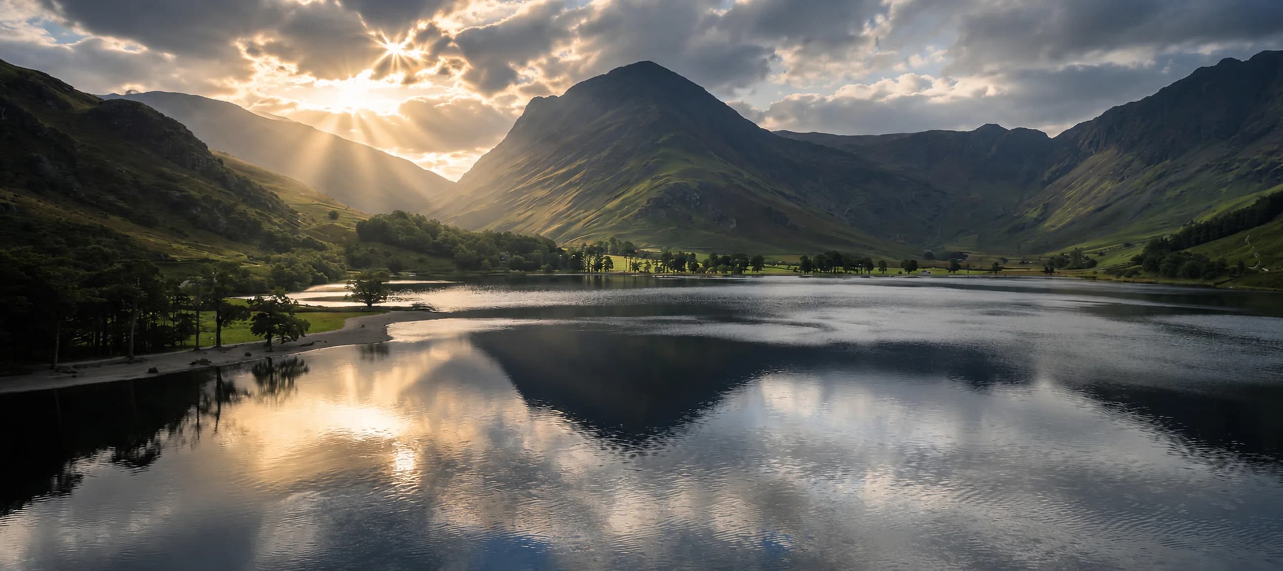 Mountain lake beneath dramatic sunlight